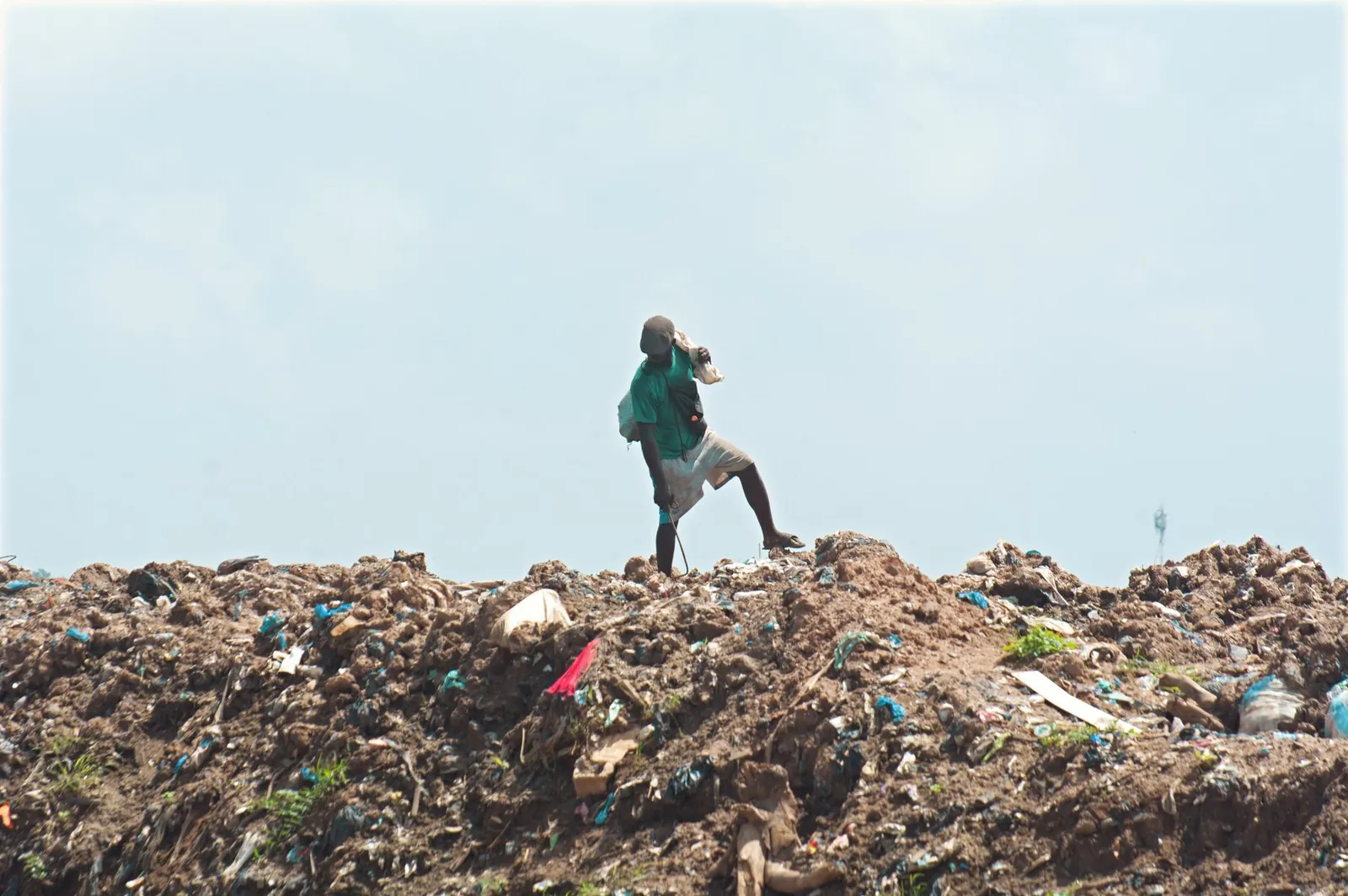 Plastic waste spread across an open dumpsite, material that never reached a recycler